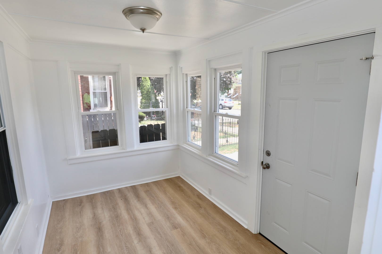 507 Grant Avenue Joliet, IL 60433 - Photo 2 of 16 a view of an empty room with wooden floor and a window