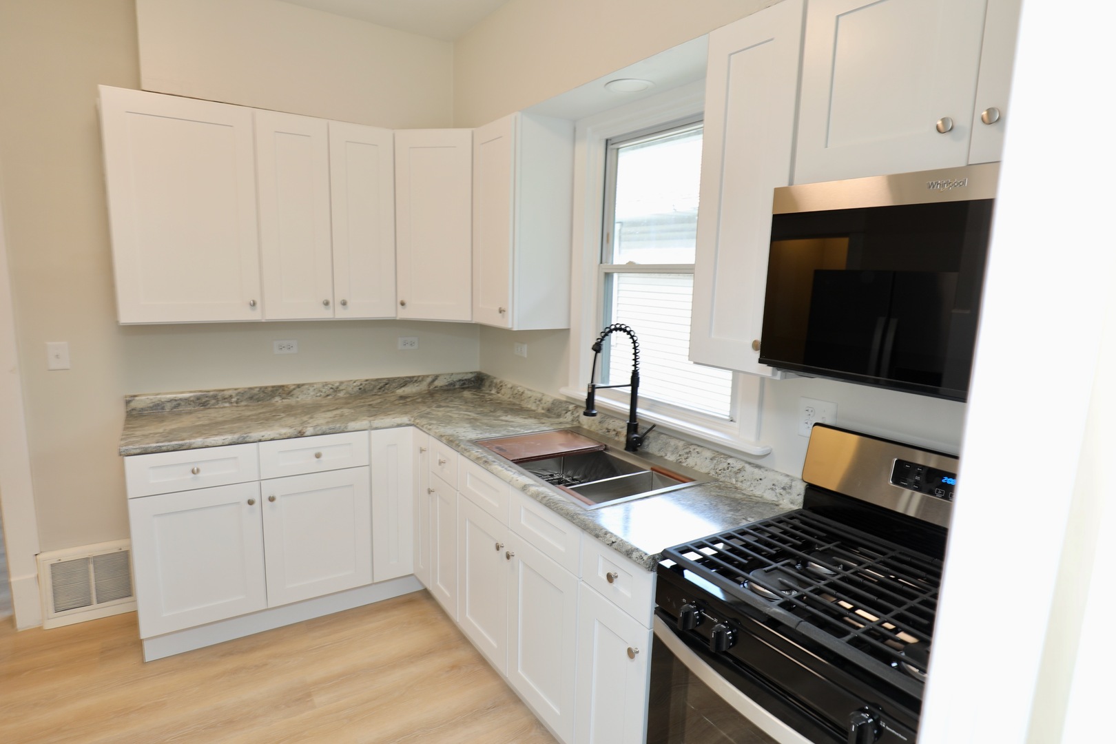 507 Grant Avenue Joliet, IL 60433 - Photo 4 of 16 a kitchen with granite countertop a stove and a sink