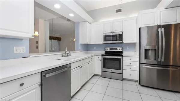 a kitchen with a refrigerator and a stove
