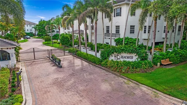 a view of a patio with a table and chairs plants and palm trees