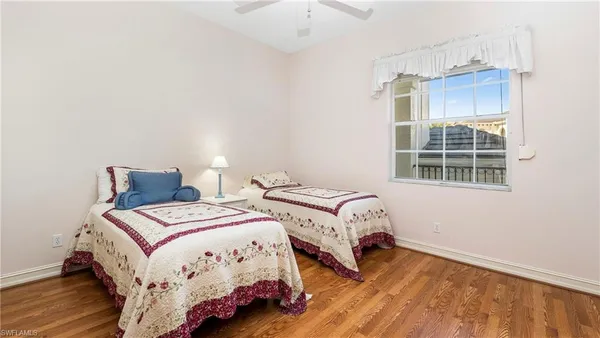 a bedroom with two beds and a window