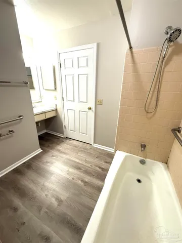 a bathroom with a bathtub and a shower