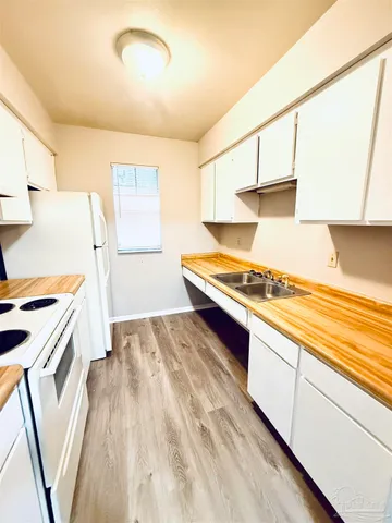 a kitchen with stainless steel appliances granite countertop a sink and cabinets
