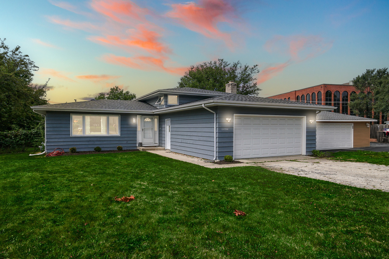 1S550 Nimitz Road Oakbrook Terrace, IL 60181 - Photo 1 of 23 a front view of a house with a garden