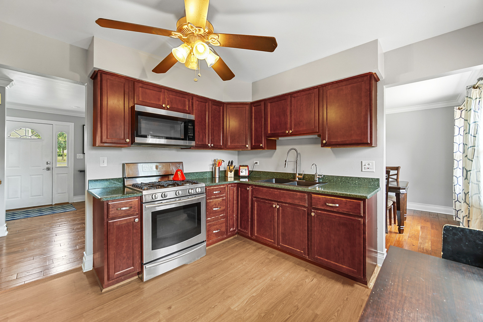 1S550 Nimitz Road Oakbrook Terrace, IL 60181 - Photo 18 of 23 a kitchen with stainless steel appliances granite countertop a stove top oven a sink dishwasher and a microwave oven with cabinets