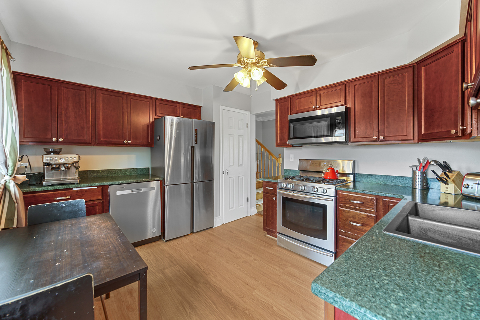 1S550 Nimitz Road Oakbrook Terrace, IL 60181 - Photo 19 of 23 a kitchen with stainless steel appliances granite countertop a refrigerator stove top oven a sink and dishwasher
