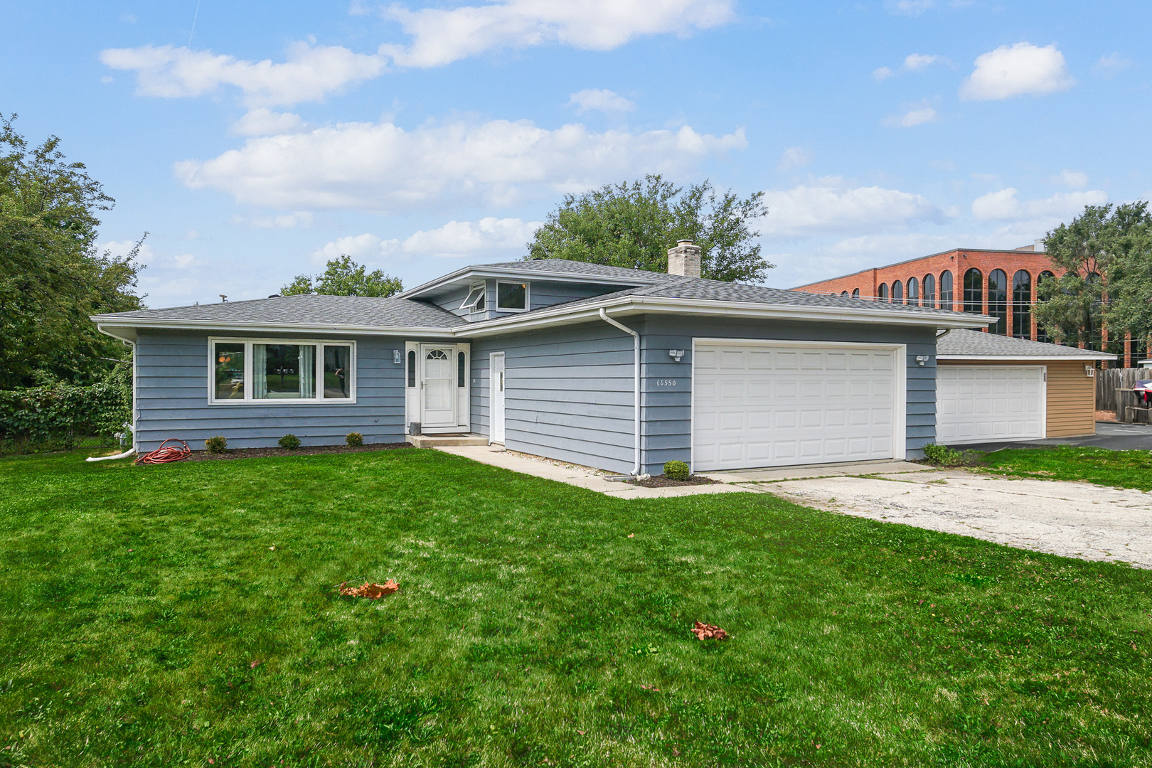 1S550 Nimitz Road Oakbrook Terrace, IL 60181 - Photo 2 of 23 a front view of a house with a garden and yard
