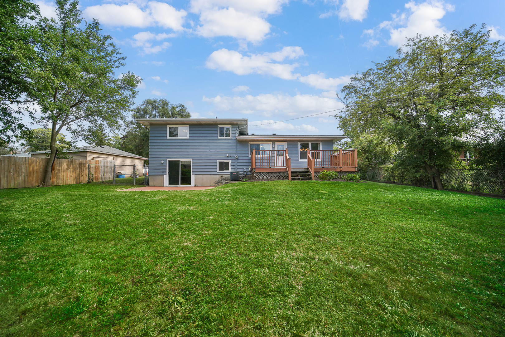 1S550 Nimitz Road Oakbrook Terrace, IL 60181 - Photo 3 of 23 a view of a house with a big yard and large tree