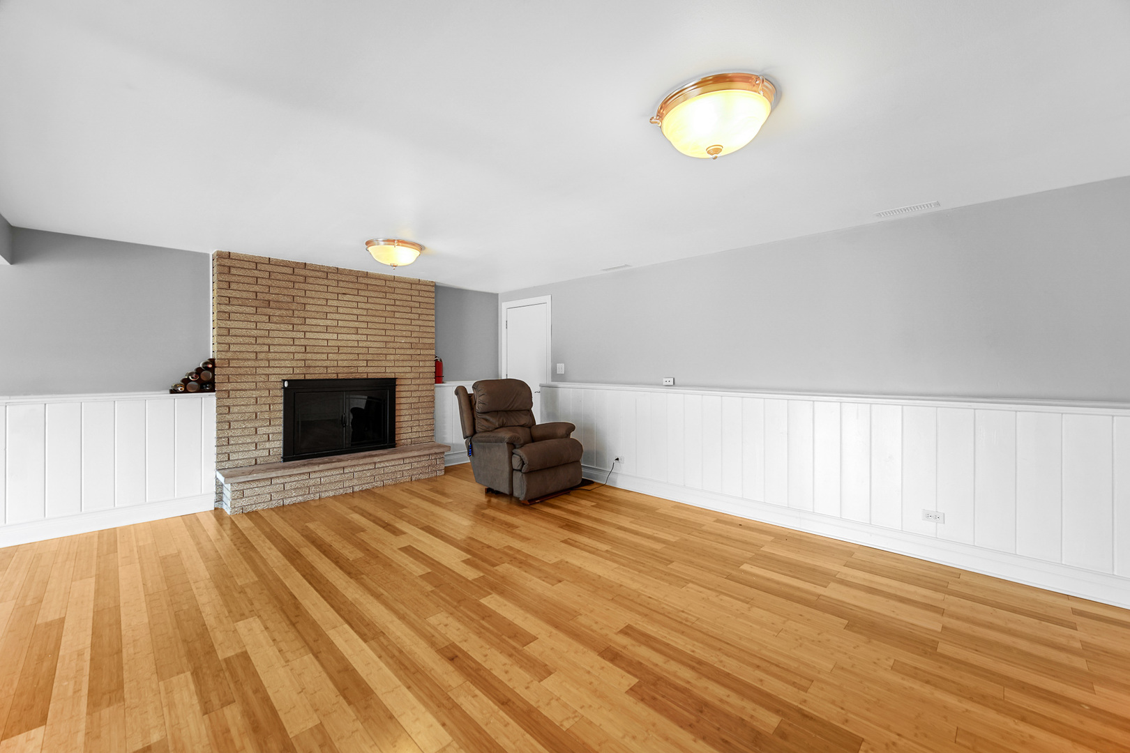 1S550 Nimitz Road Oakbrook Terrace, IL 60181 - Photo 10 of 23 a view of a livingroom with wooden floor and a fireplace