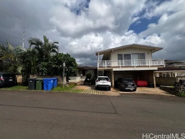a view of house with outdoor space and car parked