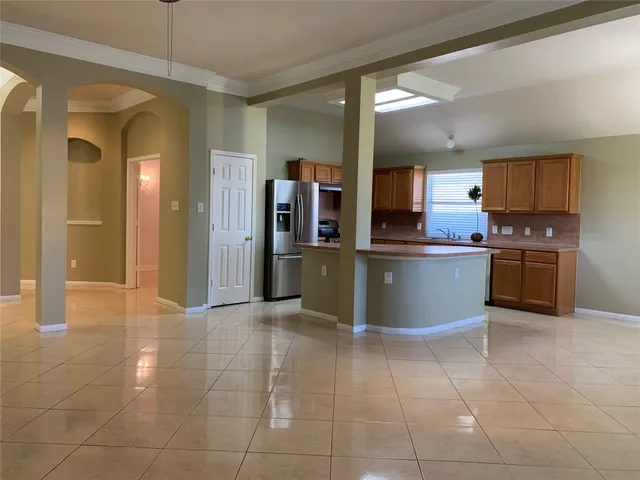 a view of kitchen with stainless steel appliances granite countertop a sink counter space and cabinets