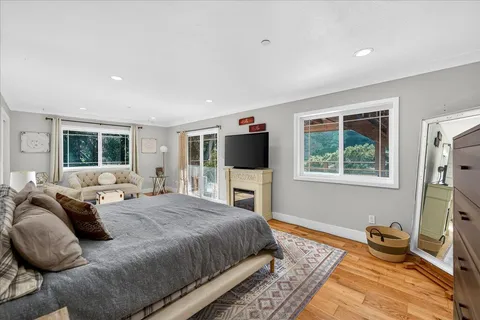 a spacious bedroom with a bed and a flat screen tv