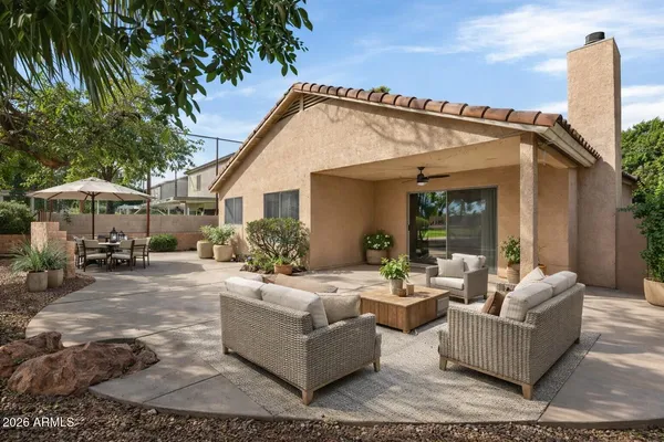 a view of a house with backyard and sitting area