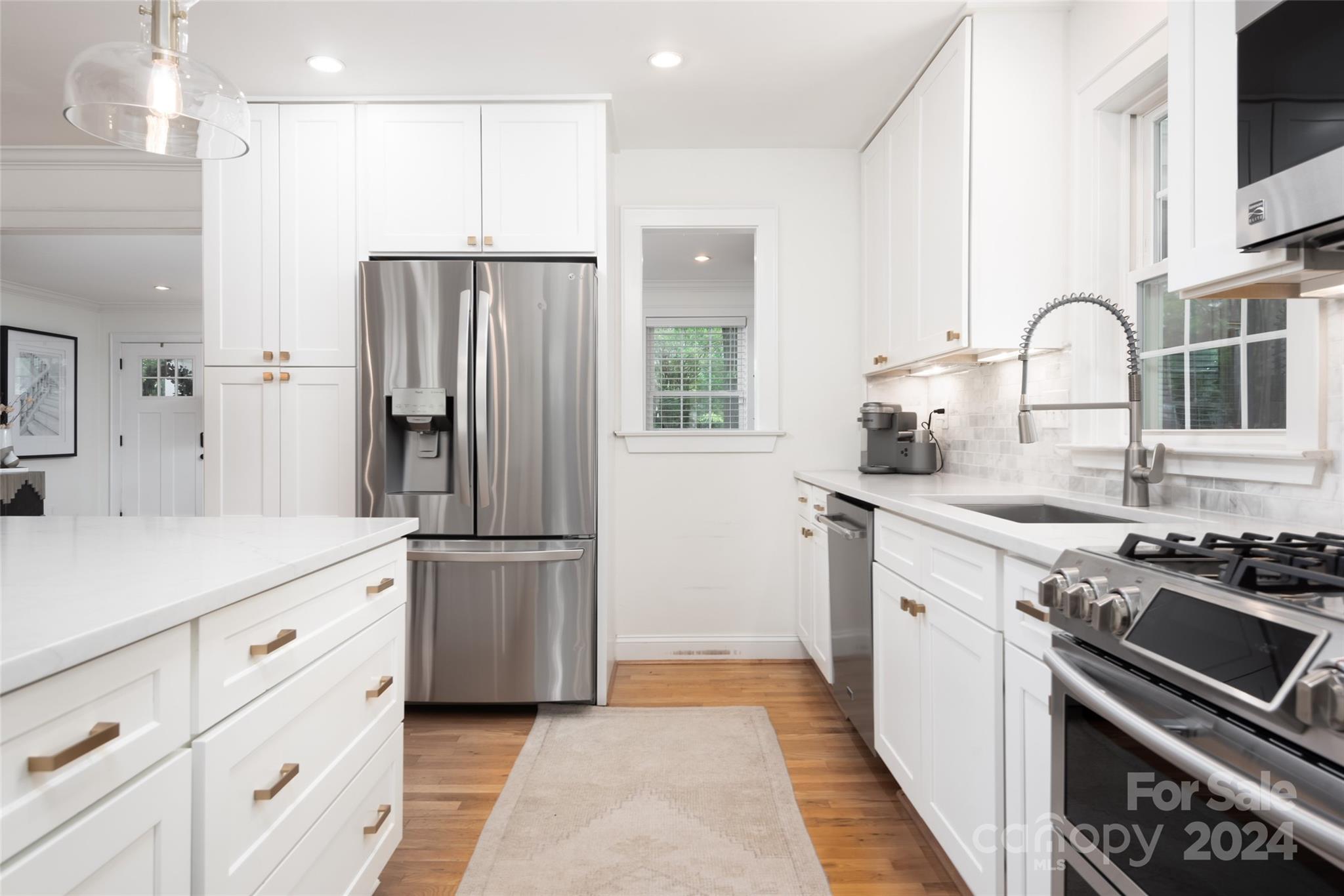 665 Marsh Road Charlotte, NC 28209 - Photo 11 of 31 a kitchen with kitchen island granite countertop a sink stainless steel appliances and cabinets