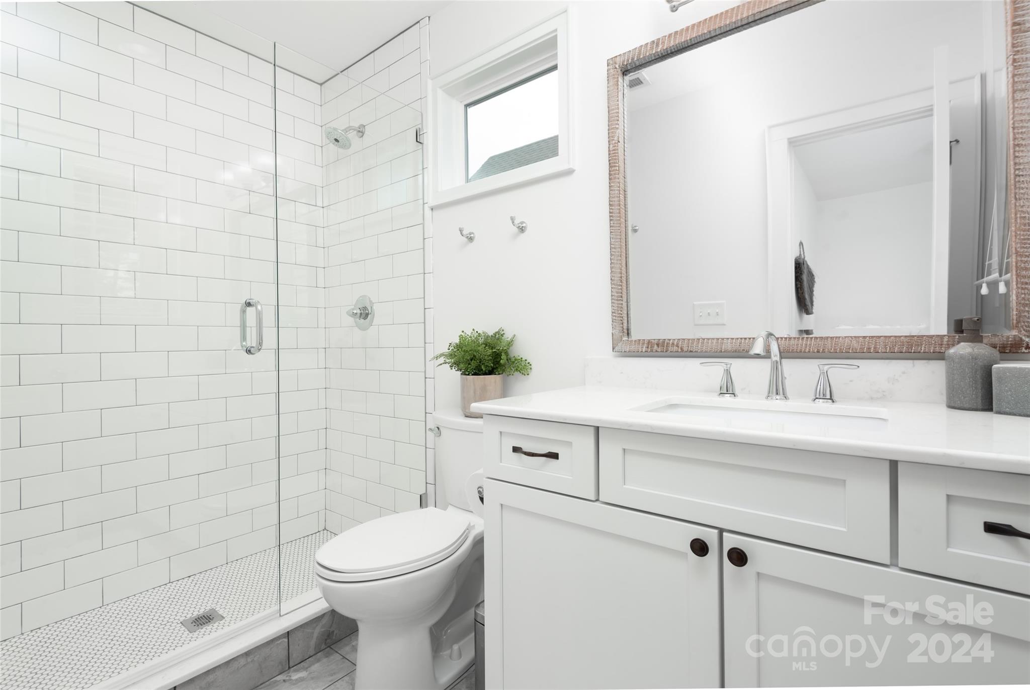 665 Marsh Road Charlotte, NC 28209 - Photo 19 of 31 a bathroom with a sink a toilet and shower