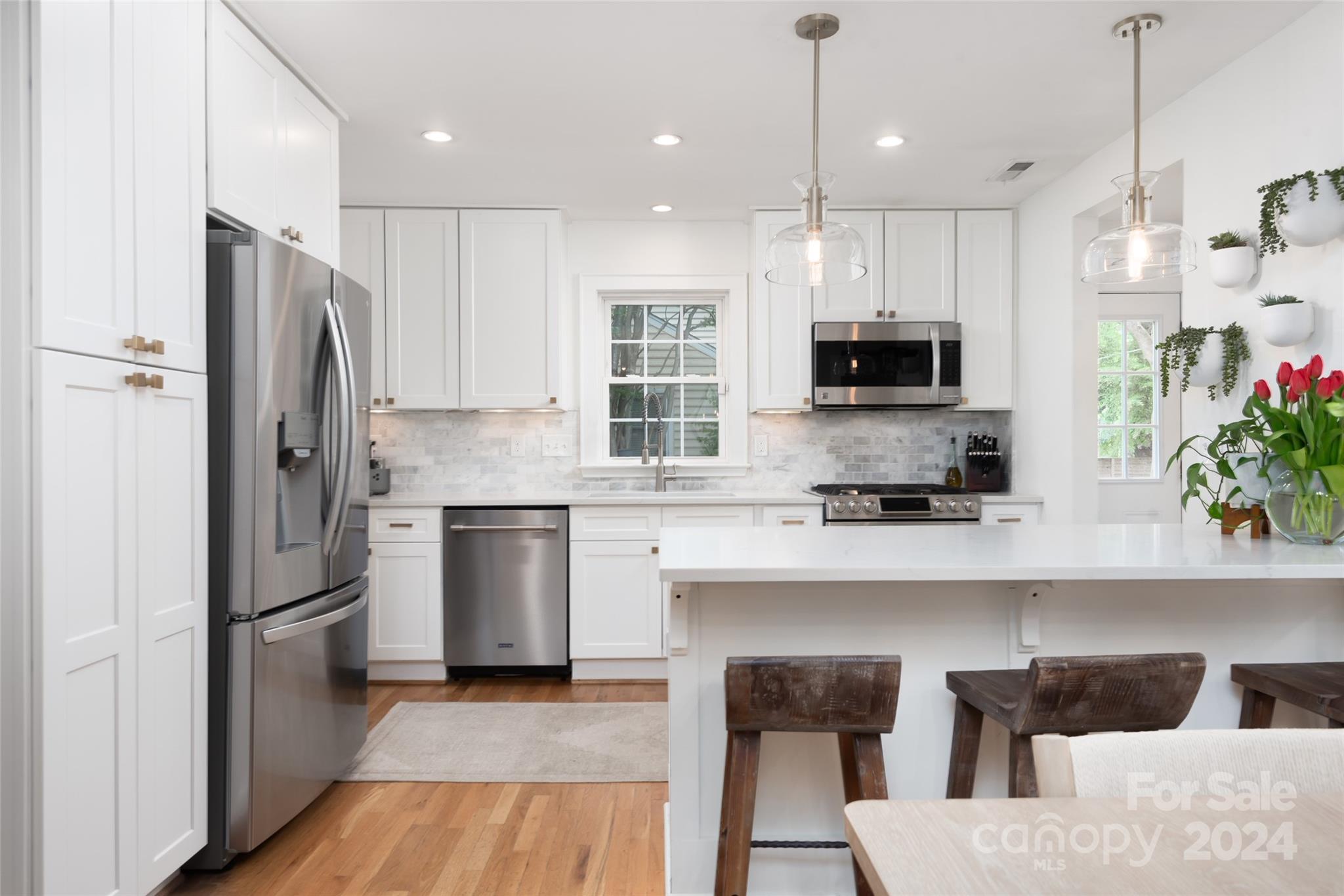 665 Marsh Road Charlotte, NC 28209 - Photo 10 of 31 a kitchen with cabinets and stainless steel appliances