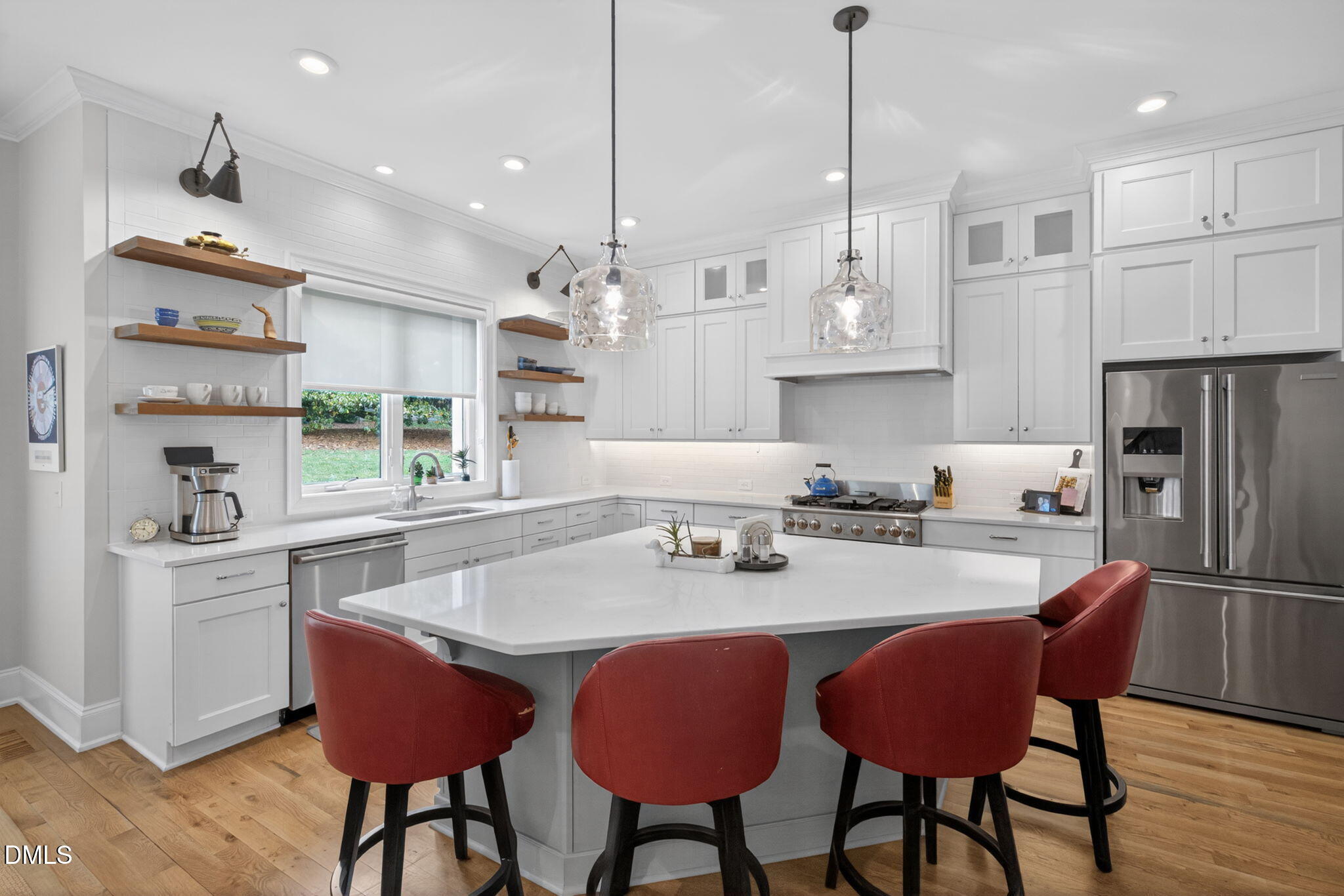 6901 Ray Family Farm Court Raleigh, NC 27613 - Photo 10 of 52 a kitchen with stainless steel appliances granite countertop a kitchen island a stove a table and chairs in it