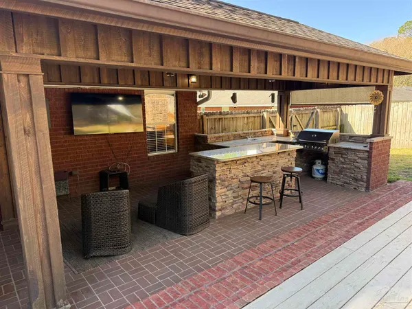 a view of a patio with a table and chairs
