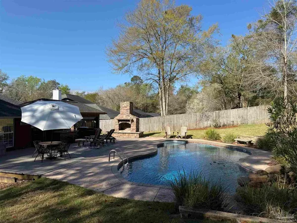 a view of a swimming pool with an outdoor space and seating area