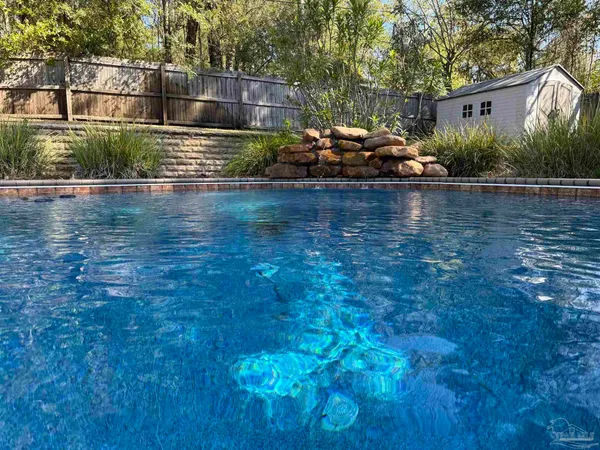 a view of a swimming pool with a yard