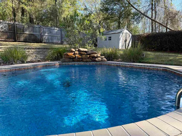 a view of a swimming pool with lounge chairs