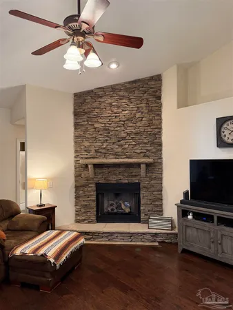 a kitchen with stainless steel appliances kitchen island granite countertop a stove refrigerator and cabinets