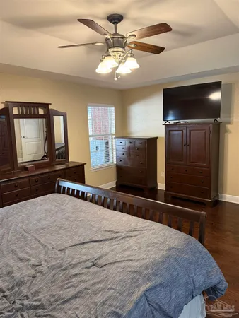 a bedroom with furniture and flat screen tv
