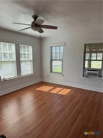 a kitchen with stainless steel appliances granite countertop a sink window and cabinets