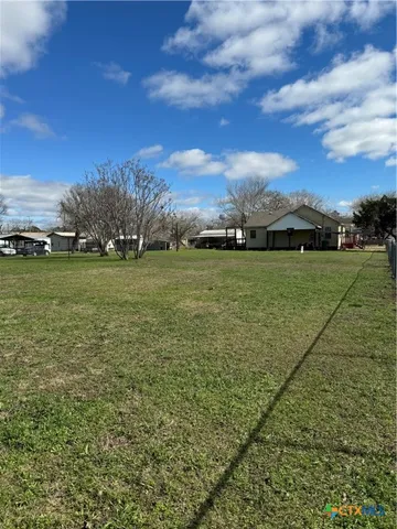 a view of a field with an ocean