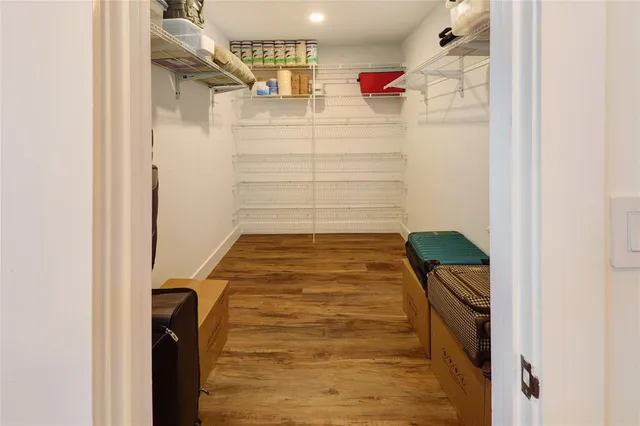 a bedroom with a bed window and a flat tv screen