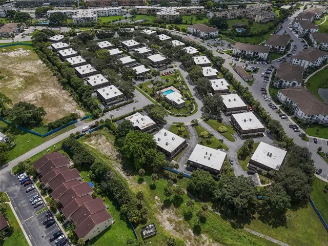 an aerial view of a house a yard and a swimming pool