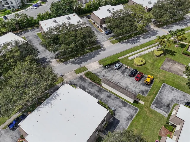 an aerial view of a house with a yard