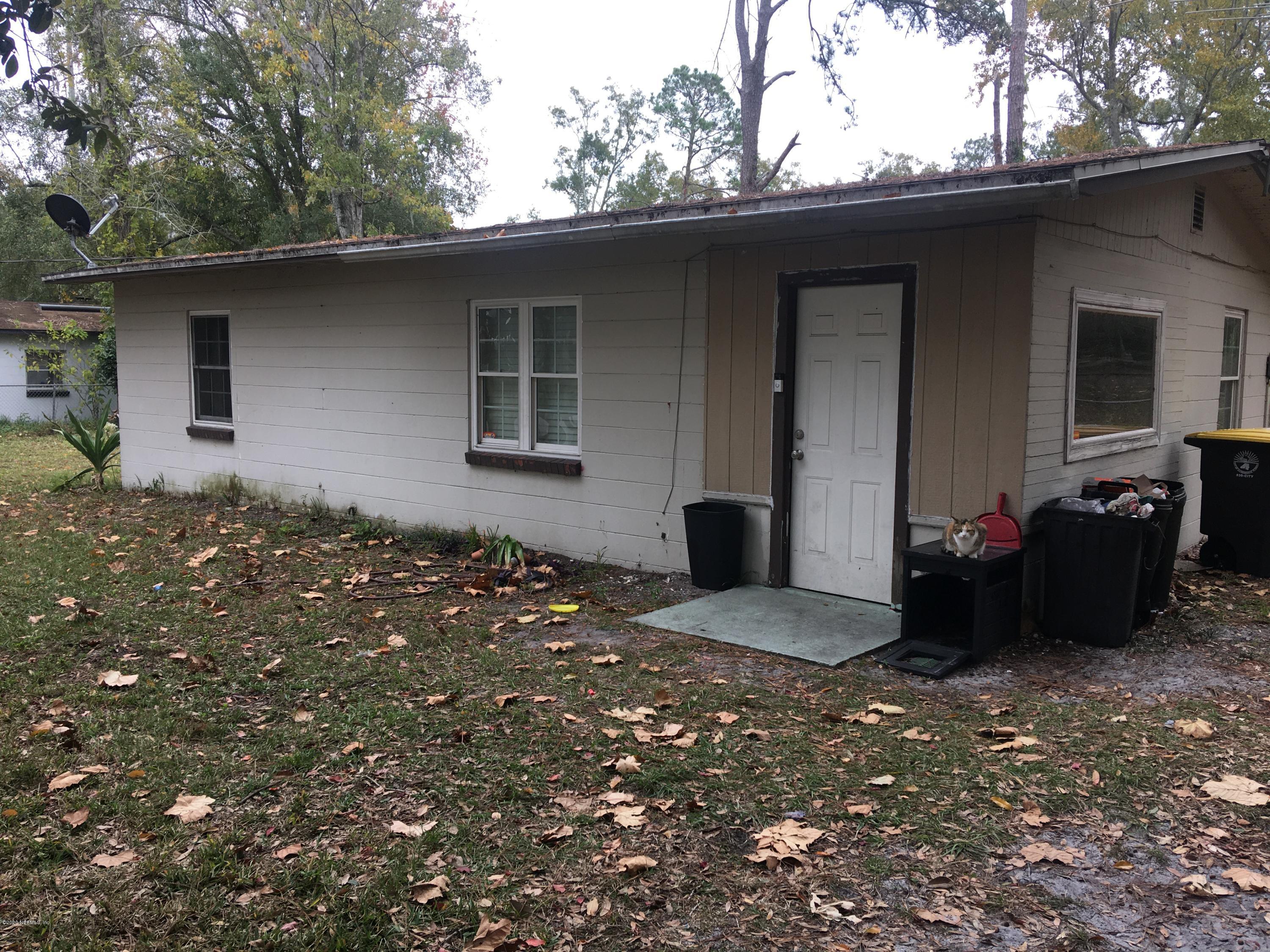 7222 Ridgeway Road North Jacksonville, FL 32244 - Photo 1 of 8 a backyard of a house with table and chairs