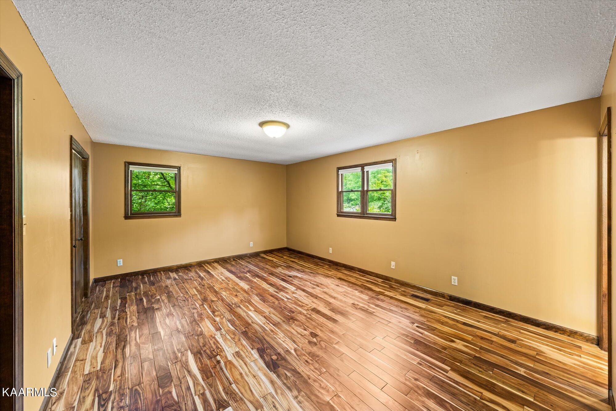 127 Chestnut Hill Road Oak Ridge, TN 37830 - Photo 20 of 45 a view of an empty room with wooden floor and a window