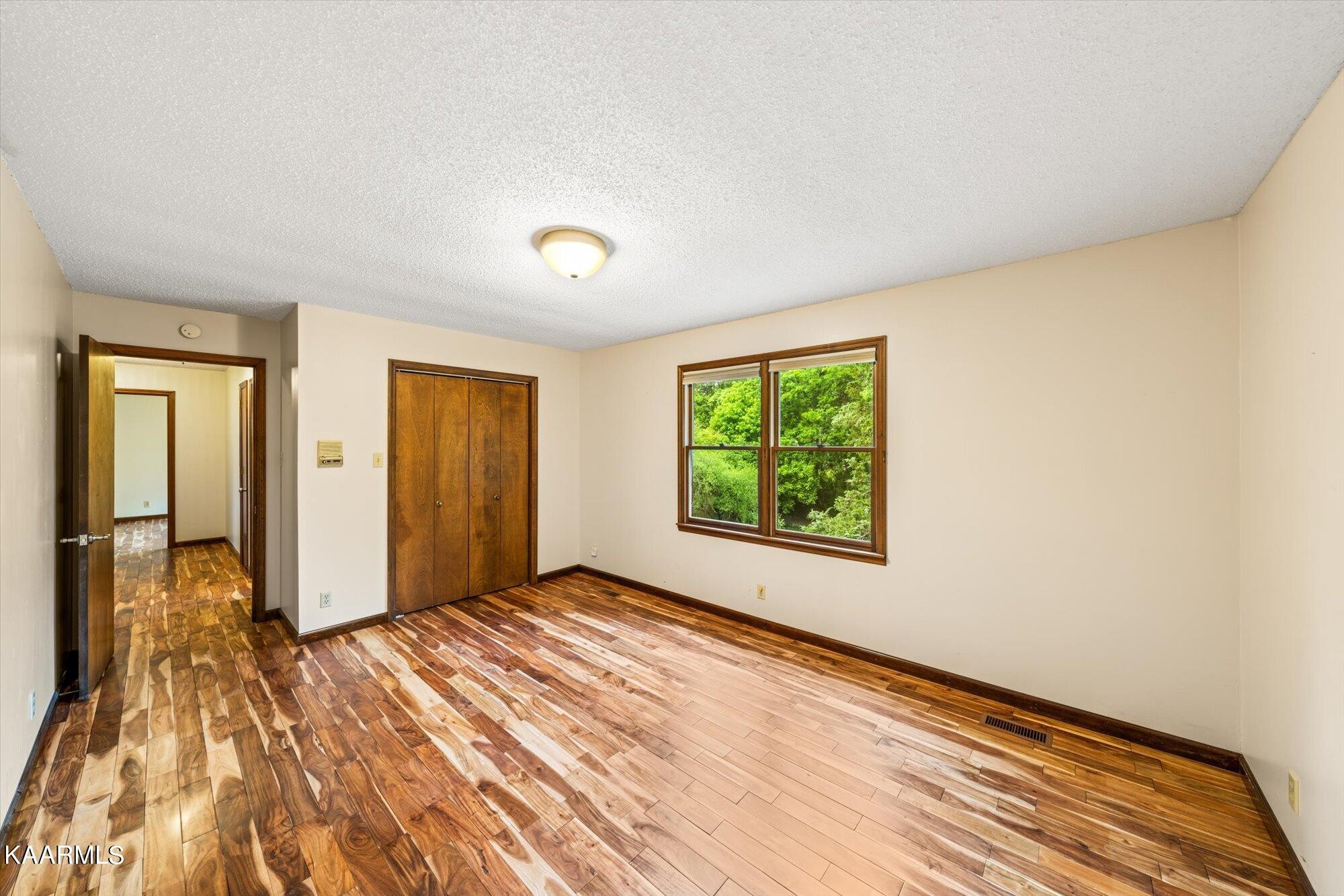 127 Chestnut Hill Road Oak Ridge, TN 37830 - Photo 23 of 45 an empty room with wooden floor and windows