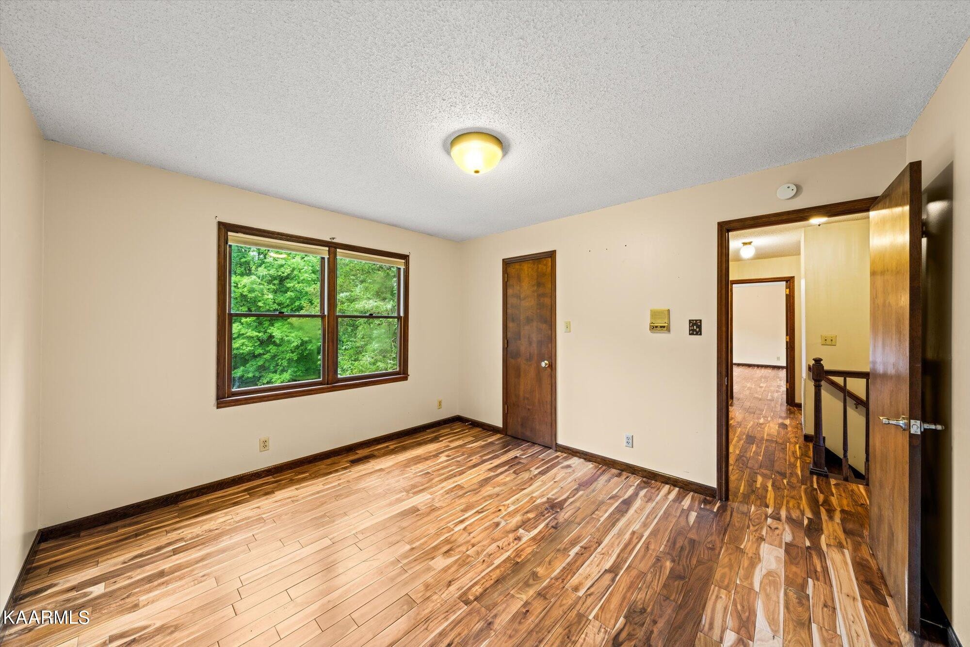 127 Chestnut Hill Road Oak Ridge, TN 37830 - Photo 25 of 45 a view of an empty room with window and wooden floor