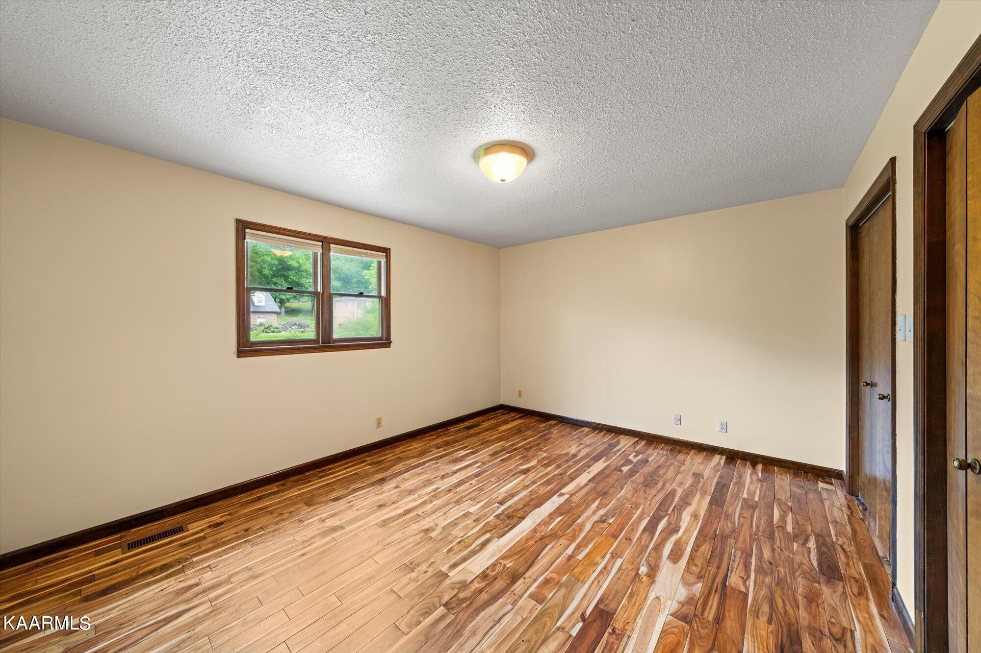 127 Chestnut Hill Road Oak Ridge, TN 37830 - Photo 26 of 45 an empty room with wooden floor and windows