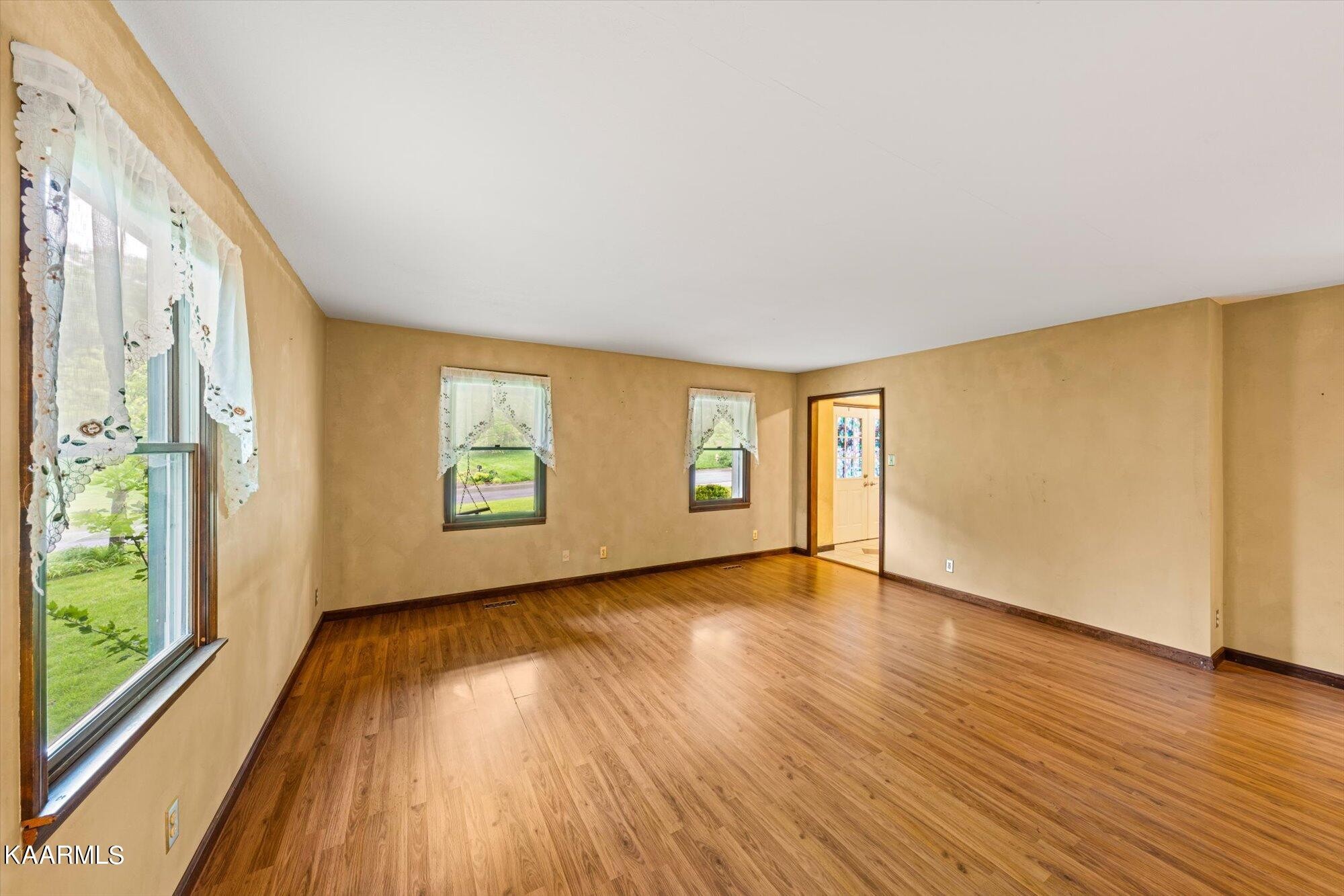 127 Chestnut Hill Road Oak Ridge, TN 37830 - Photo 8 of 45 a view of an empty room with wooden floor and a window