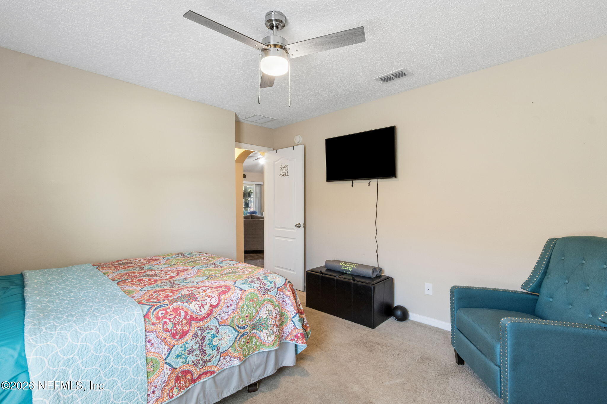 96034 Bass Lane Yulee, FL 32097 - Photo 35 of 50 a bedroom with a bed and a flat screen tv