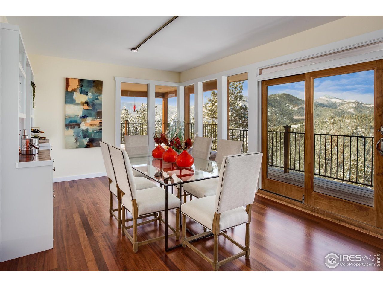 90 Commander Spur Boulder, CO 80302 - Photo 13 of 40 a dining room with furniture large windows and wooden floor