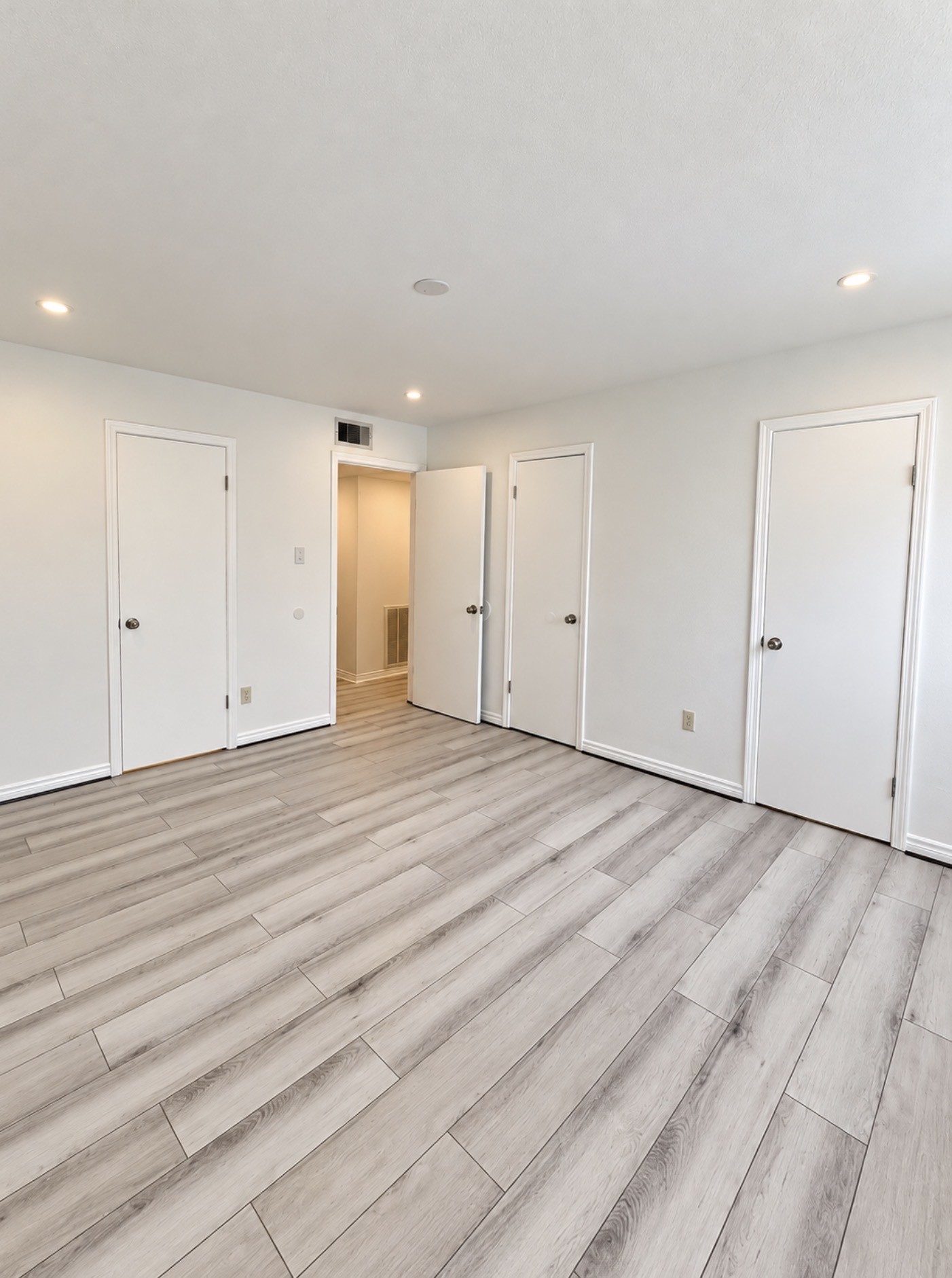 9616 Long Point Road, Unit 63 Houston, TX 77055 - Photo 7 of 18 Another shot of the primary bedroom with a view of the two doors on the right to the closet and the door on the left is to the en-suite bathroom