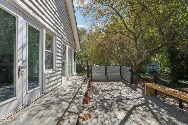 a view of a chairs and fire pit in the backyard of a house
