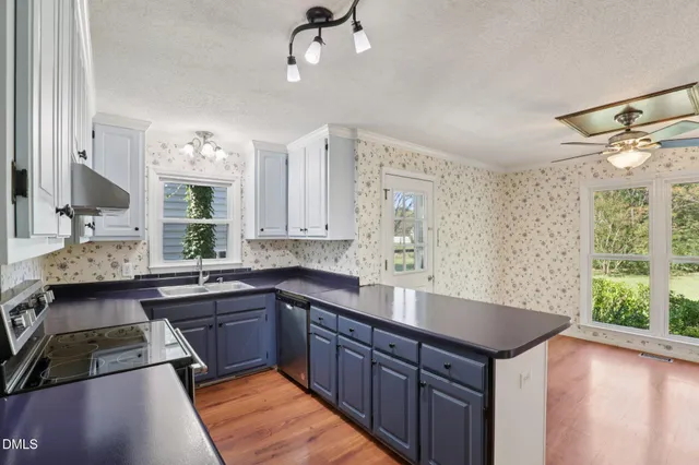 a kitchen with a sink and a stove top oven