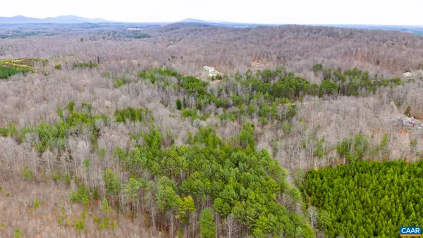 a view of a lush green hillside and a building