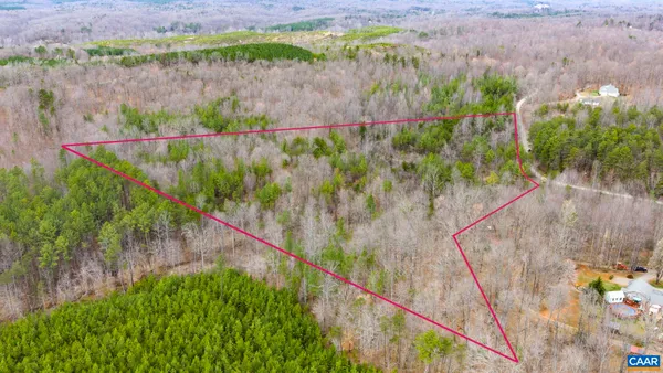 a view of a lush green hillside and a houses