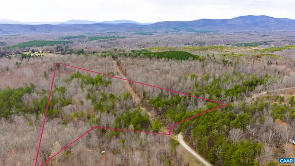a view of a lush green hillside and a building