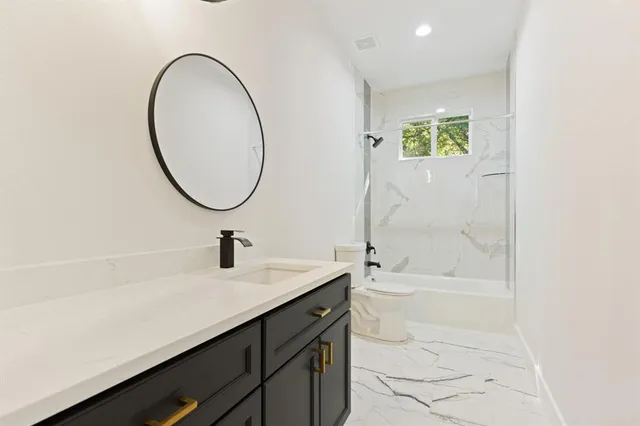 a bathroom with a sink a toilet and a bathtub