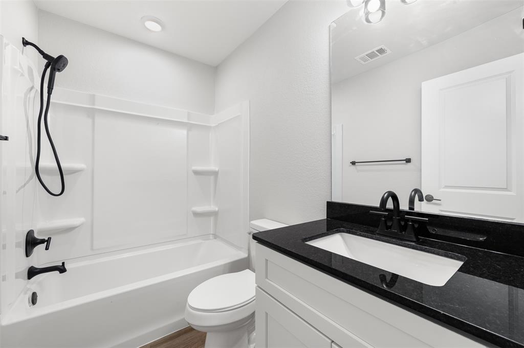 1536 Alexander Avenue, Unit A & B Waco, TX 76708 - Photo 22 of 30 The bathroom features a white vanity with a black granite countertop and an undermount sink
