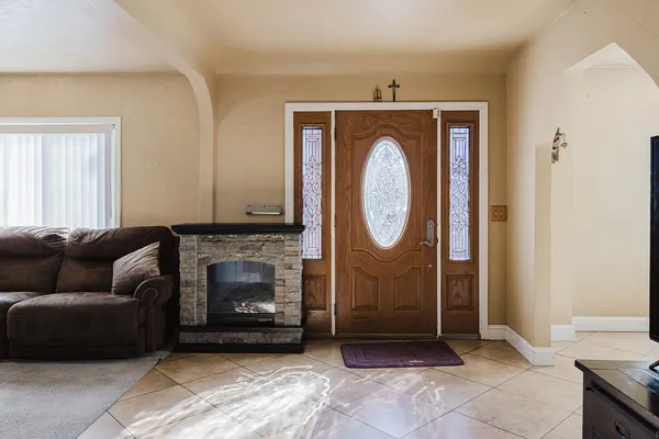 a living room with furniture a mirror and a fireplace
