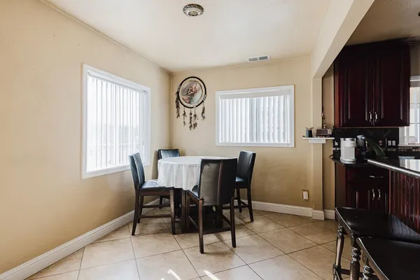 a view of a dining room with furniture and window